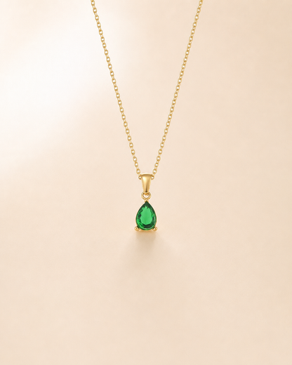 A single pear cut emerald crystal suspended from a minimalistic chain. Simple, rich and quietly luxurious - the kind of green that turns heads without trying.
